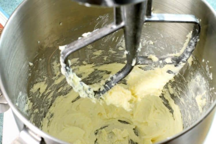 Butter being creamed in a kitchen aid stand mixer for muffin batter