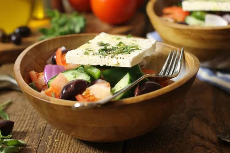 Horiatiki or traditional Greek salad in a wooden bowl