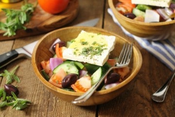 traditional greek salad known in greece as horiatiki, served in a rustic wooden bowl