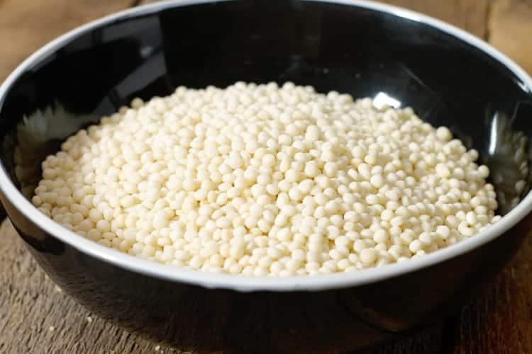 close up shot of a black bowl filled with israeli couscous, also called pearl couscous