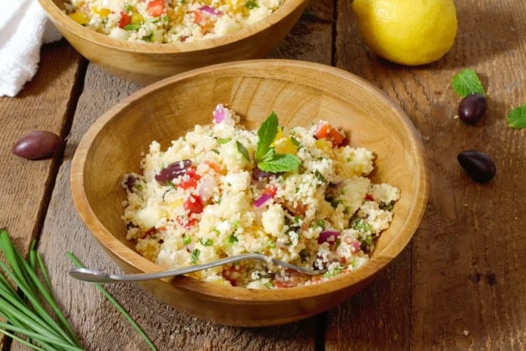 close up shot of Mediterranean Couscous Salad in a wooden bowl