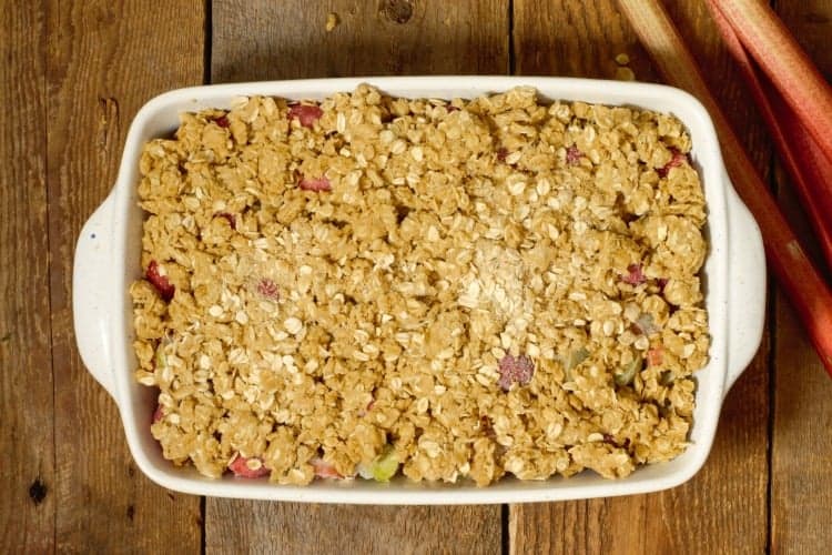 unbaked strawberry rhubarb crumble in a stone casserole dish