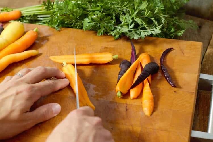 cutting trimmed baby carrots in half