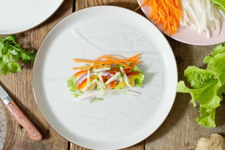 vietnamese spring roll wrapper being topped with various ingredients