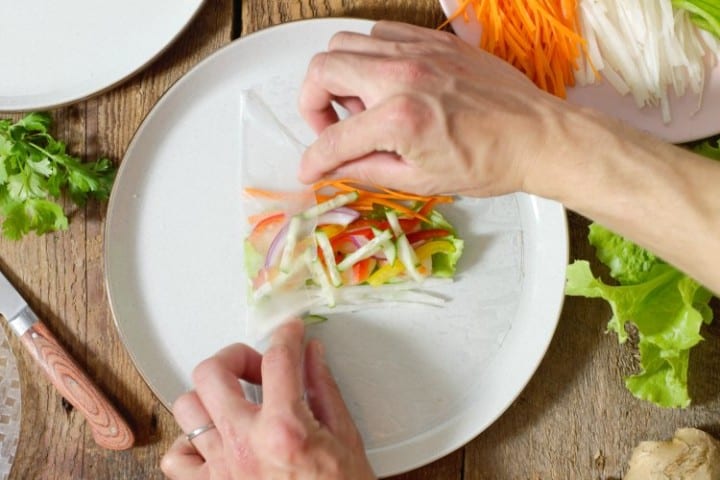 showing how to properly roll a rice paper roll