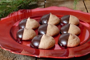 chocolate meringue cookies served on a red holiday themed platter