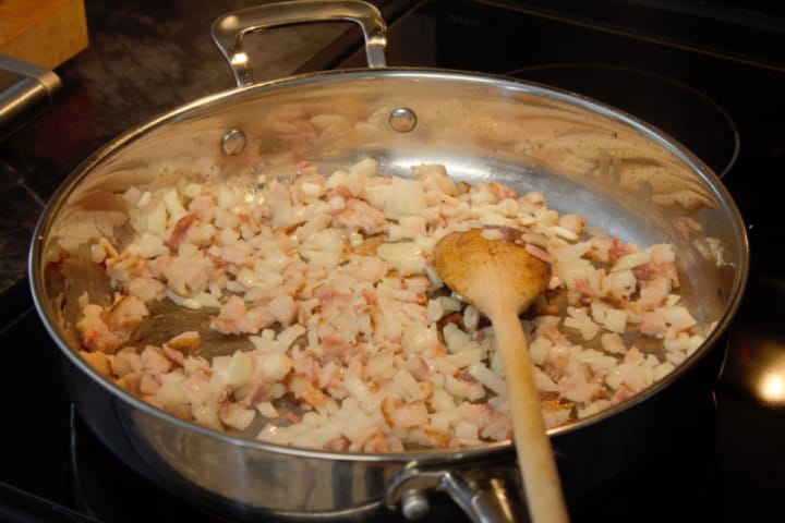 cooking chopped onions and garlic together in a pan