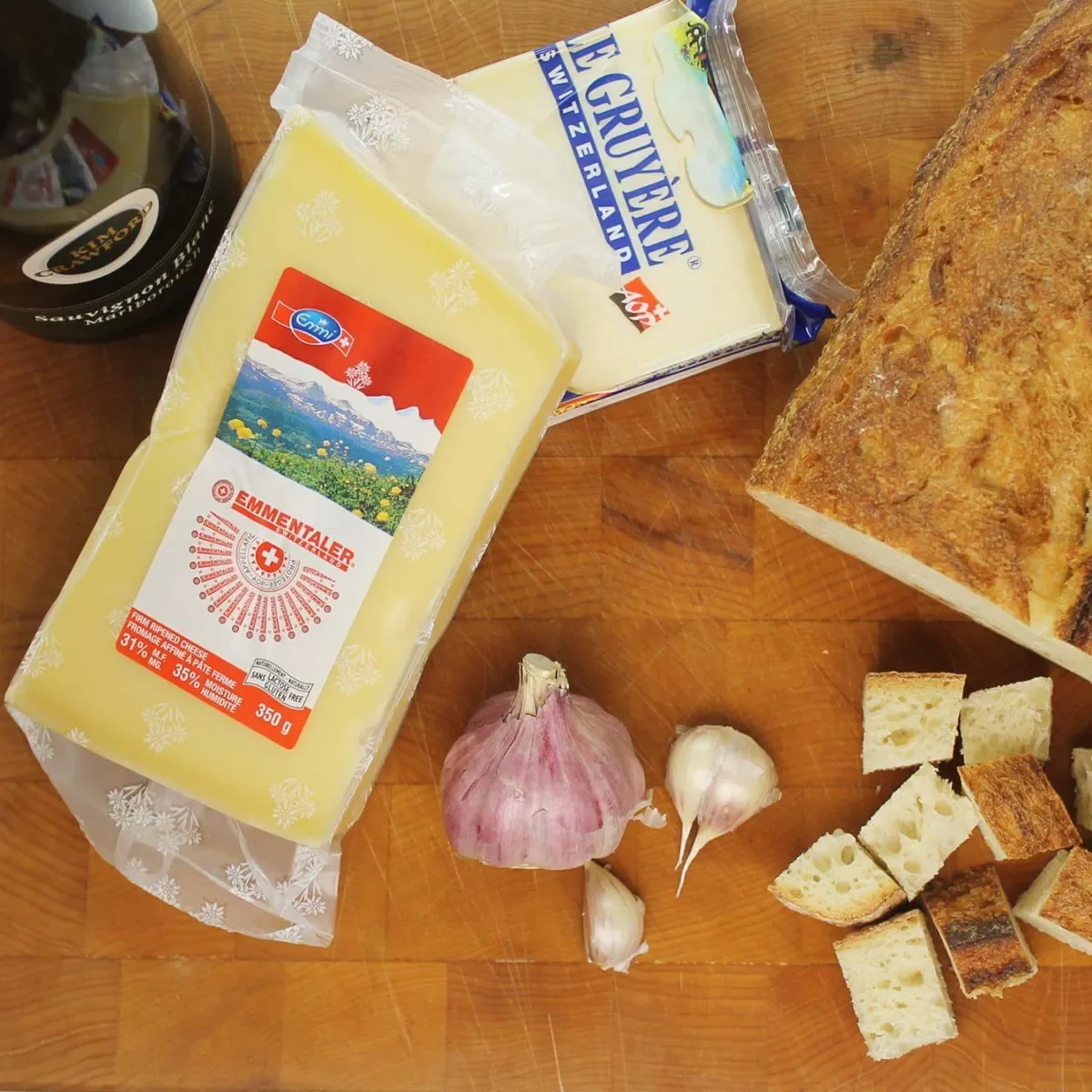 Gruyère cheese and Emmentaler cheese selection for Swiss fondue cheese accompanied with red wine and sourdough bread