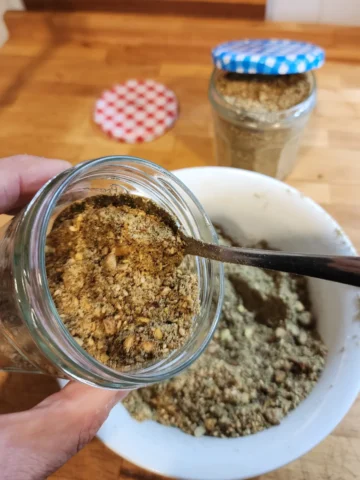 Transfering Dukkah spice to a glass jar.